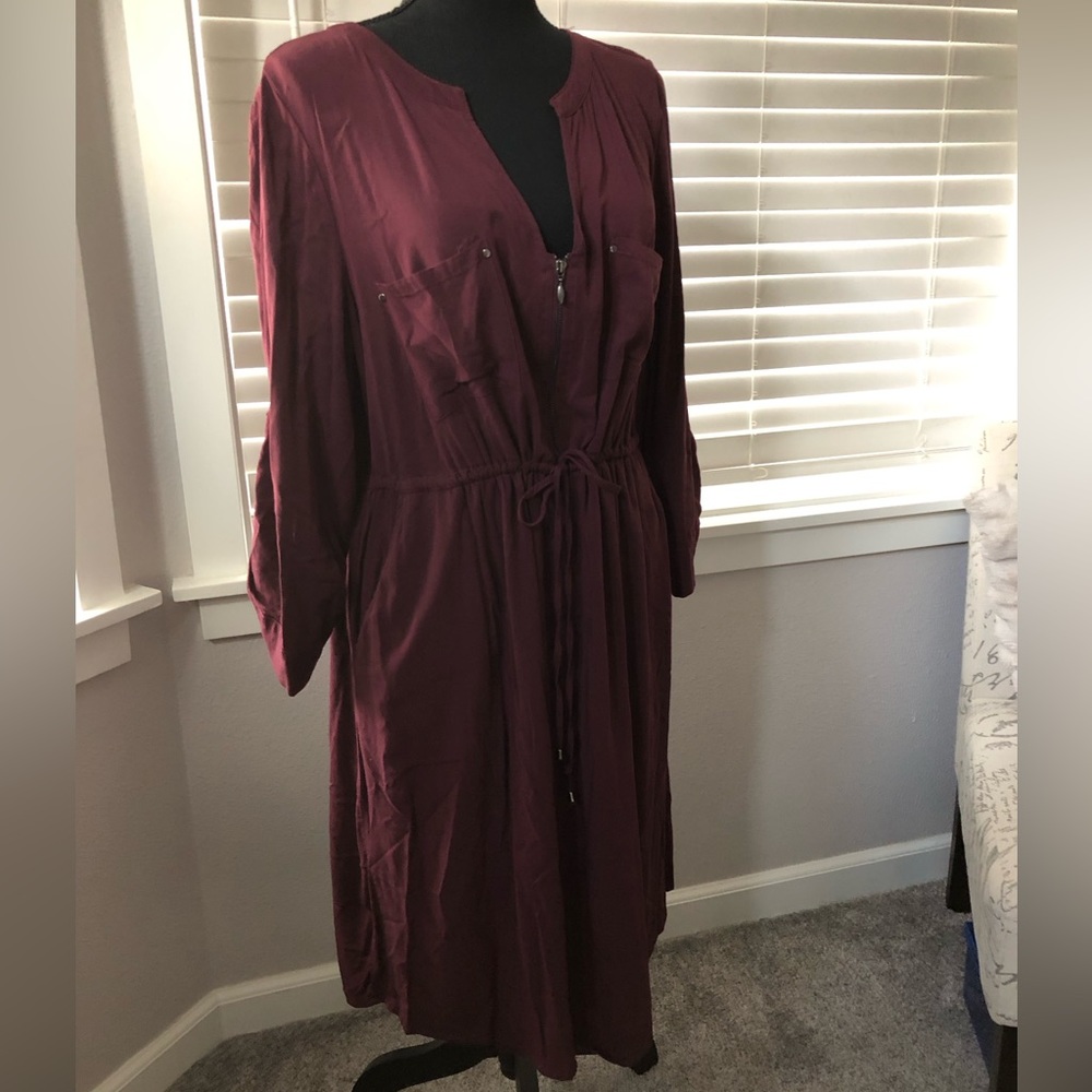 Mid length wine colored dress with pockets and zipper details.